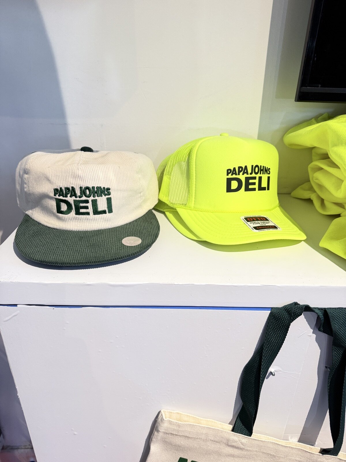 Embroidered caps on display at a Merch Troop live event